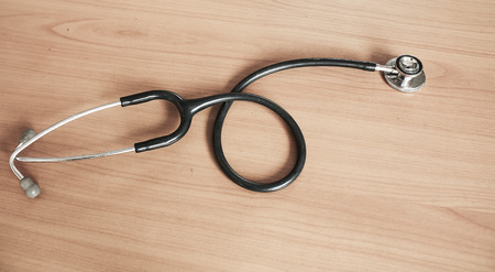 Still Life-Through the use of state Stethoscope  on a wooden floor. Vintage Tone.の写真素材