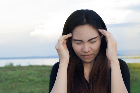 Women took the head Headache air show Twilight sky backdrop.の写真素材