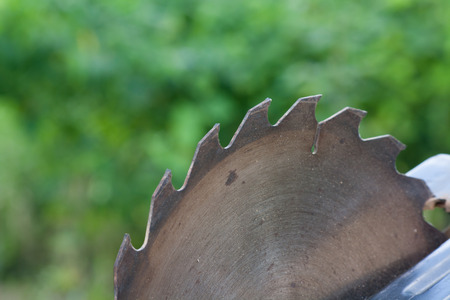 Closeup old saw blade is circular, background blur.