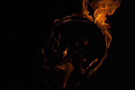 The flame glow isolated black background. Head of Fire. Flames Night Scene.