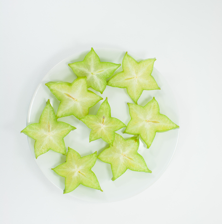 Star fruit in white container, Isolated white background.の写真素材