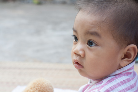 Side view of the boys were sitting, children age 6 months, Thailand.の写真素材
