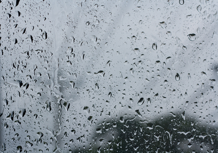 Abstract backgrounds  drops of rain on glass Overlooking the poles blur.の写真素材