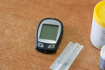 Monitoring blood glucose levels is placed on a wooden floor. Medical devices (digital).の写真素材