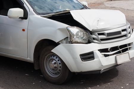 The front of the car damaged in an accident. Automobile White. Car accident on the road.の写真素材