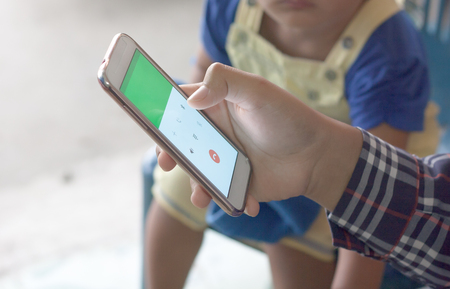 Concept to communicate. The use of smart phones for communication, background blur (children).の写真素材
