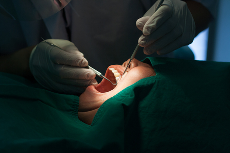 The dentist uses the patient's oral health checkup tool. Close Up.の写真素材