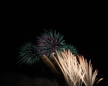 Fireworks. Fireworks show above the water surface in the park. The scene shows the night.の写真素材