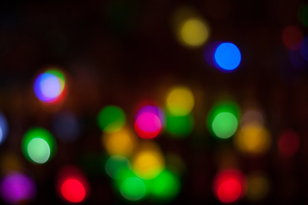 Bokeh shimmering light. Blurred multicolored lights in the darkness.の写真素材