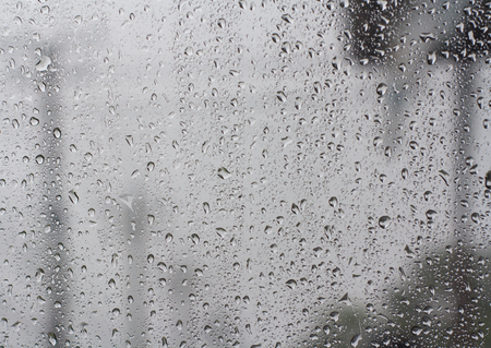 Abstract backgrounds drops of rain on glass Overlooking the poles blur.の写真素材