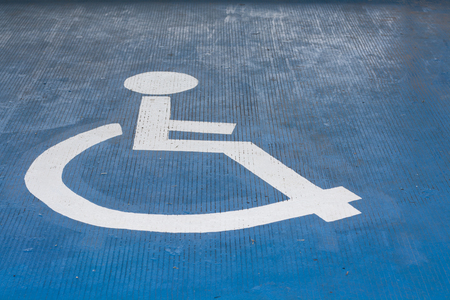 Parking lot symbol for the disabled on the concrete floor.の写真素材
