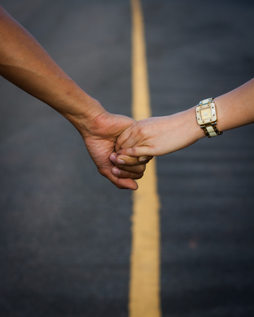 Couple walking hand in hand on the street, travel concept of love.の写真素材