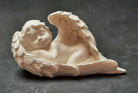 Decoration figure angel sleeping in his wingsの写真素材