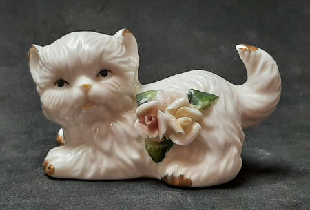 Decorative figure cat with flowers porcelain lying whiteの写真素材
