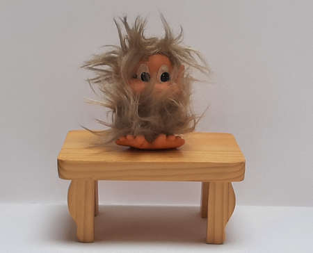 Decoration figure Troll on a small wooden tableの写真素材