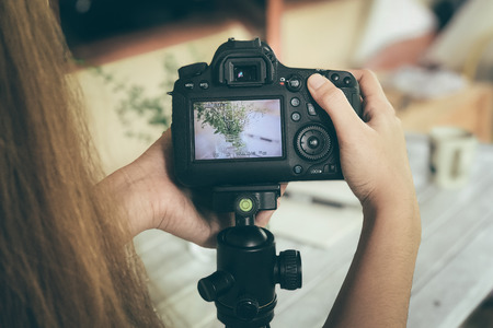Girl Using Photography of Camera of Flower Vase.の写真素材