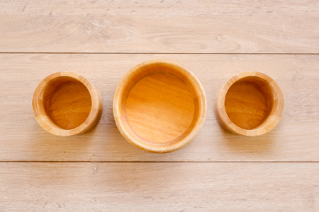 Wooden bowl on Wood Background, top view.の写真素材
