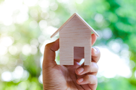 Hand Holding Wooden Toy House Madeの写真素材