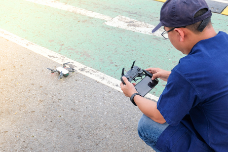 Young man operating of flying droneの写真素材
