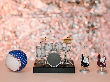 Baseball drums and bass guitar shiny pink backgroundの写真素材
