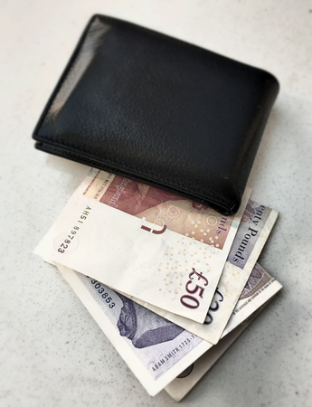 Black wallet with British poundsの写真素材