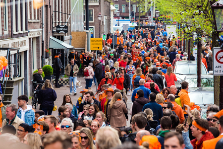Amsterdam, Netherlands - April, 2018: Crowd of people on the street celebrate Kings day in Amsterdam city, Netherlandsのeditorial素材