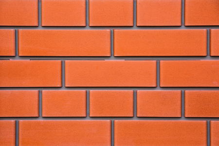 Tiles of house facade, red brick wall background.の写真素材