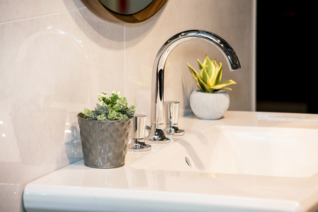 Modern washbasin with mixer tap in bathroomの写真素材