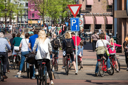 Amsterdam, Netherlands - April, 2018: Many cyclists on Amsterdam street in Netherlandsのeditorial素材
