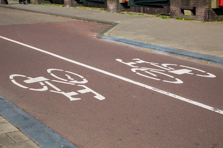 White bicycle sign on the road with two way traffic