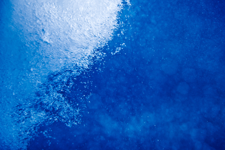 Blue clear water with bubbles, abstract liquid backgroundの写真素材