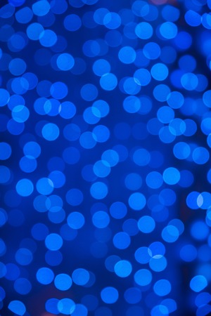Blue christmas background with colorful bokeh light effectsの写真素材