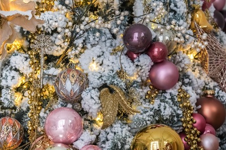 White New Year tree snow covered with toys and flashing garlandの写真素材