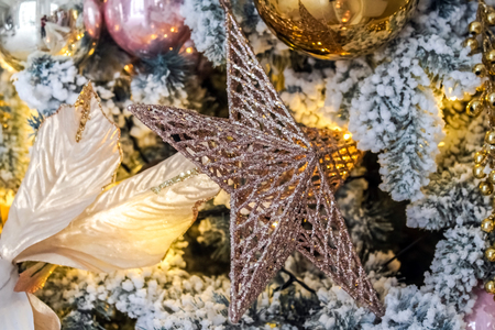 White New Year tree snow covered with toys and flashing garlandの写真素材