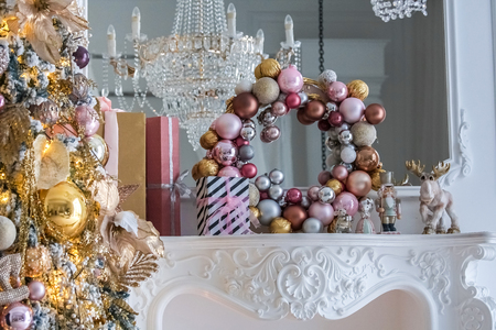 White room interior with New Year tree decorated, present boxes and fireplaceの写真素材