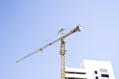 Construction crane on blue skyの写真素材