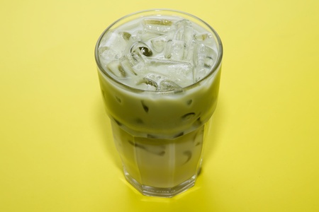 tea green ice on yellow backgroundsの写真素材