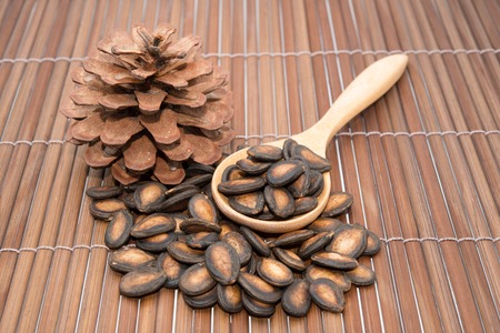 Watermelon seeds in spoons on wood backgroundsの写真素材