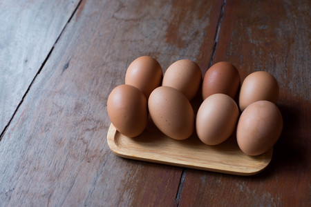 Eggs in wooden plateの写真素材