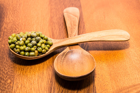 Mug beans in wood spoonsの写真素材