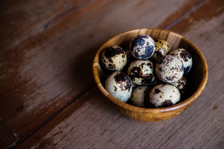 Quail eggs in wooden bowlの写真素材