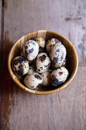 Quail eggs on wooden backgroundsの写真素材