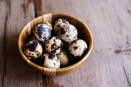 Quail eggs on wooden bowlの写真素材