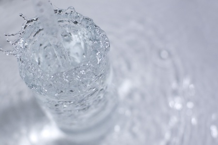 Water overflows from the glass.