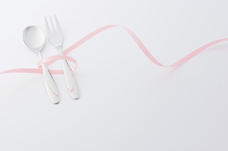 Spoon and fork wrapped in a ribbonの写真素材