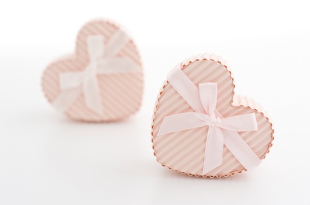 Heart-shaped gift box wrapped with a ribbon 
