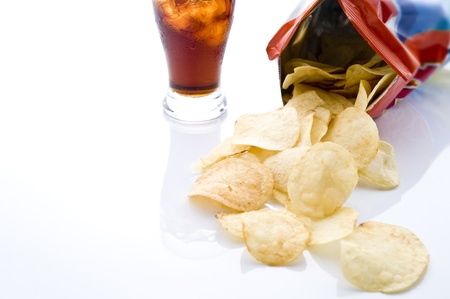 Bag of potato chips with soda on white background