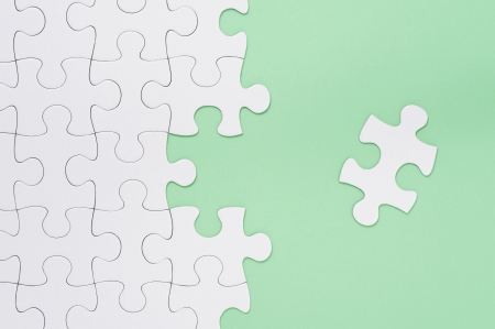 Jigsaw puzzle on green background, high angle view の写真素材