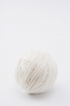 Worsted wool yarn on white background, close-up の写真素材