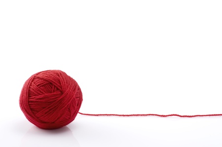 Ball of red yarn on white backgroundの写真素材